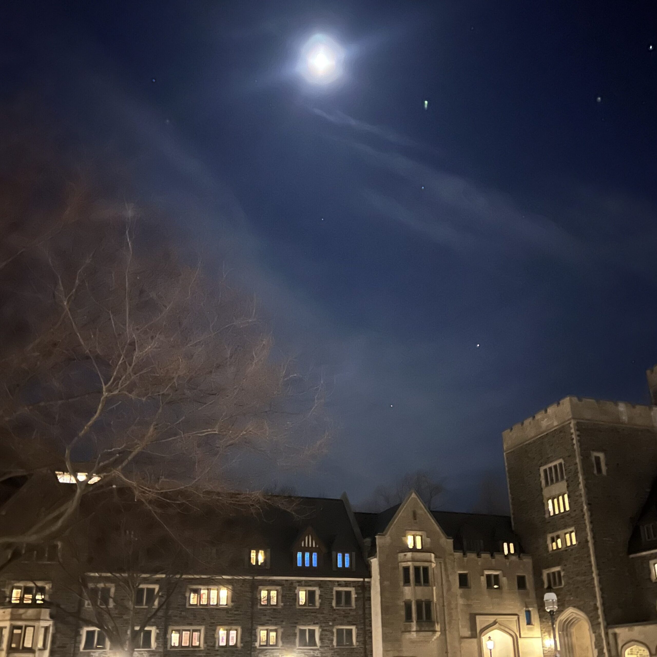 Image of night sky above a Princeton building with comet streaking overhead