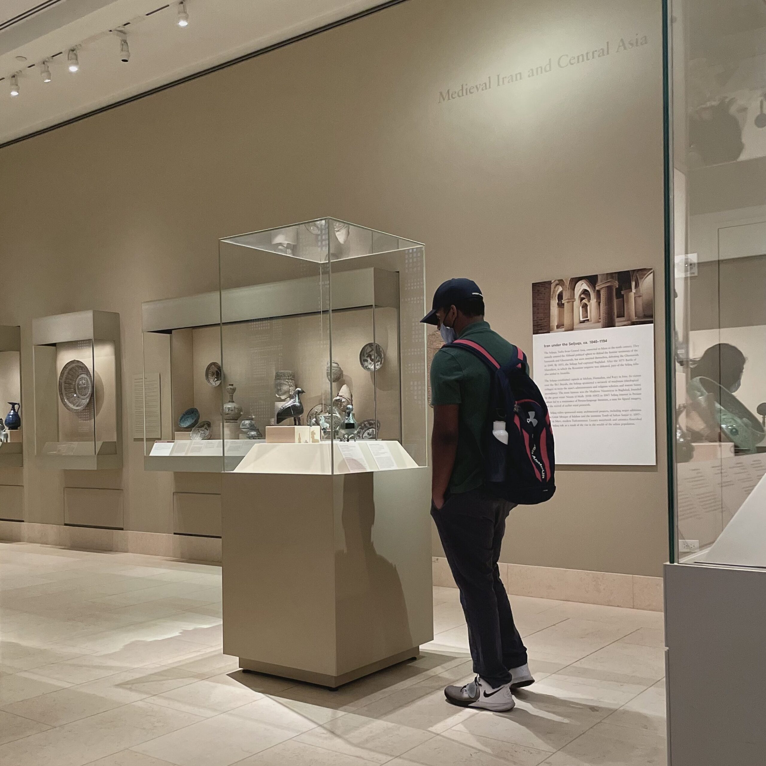 A man looking at an artifact in a display case.