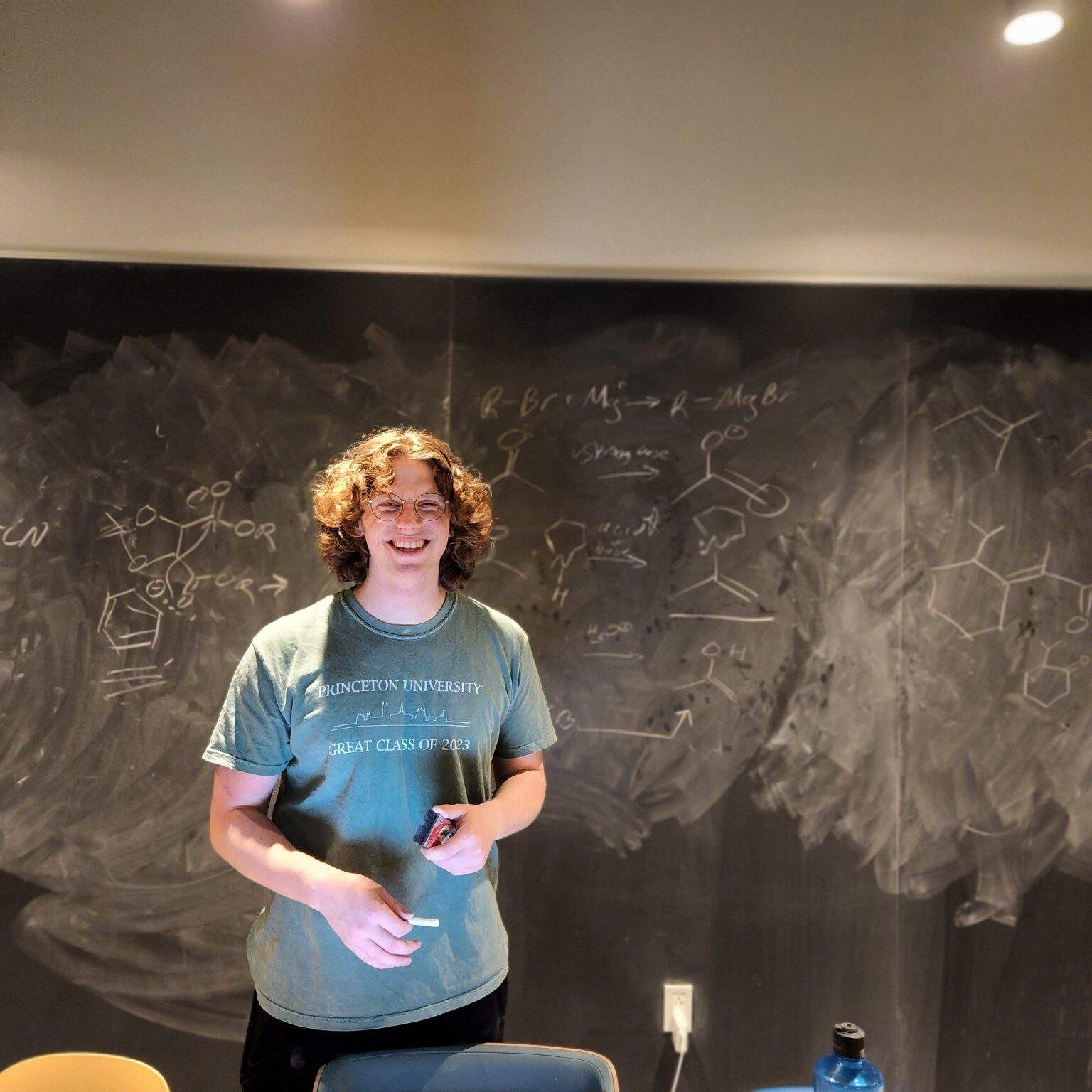 Organic Chemistry TA and Princeton Senior Tom Silldorff poses in front of a chalkboard after a long night of tutoring at the NCW dining hall.