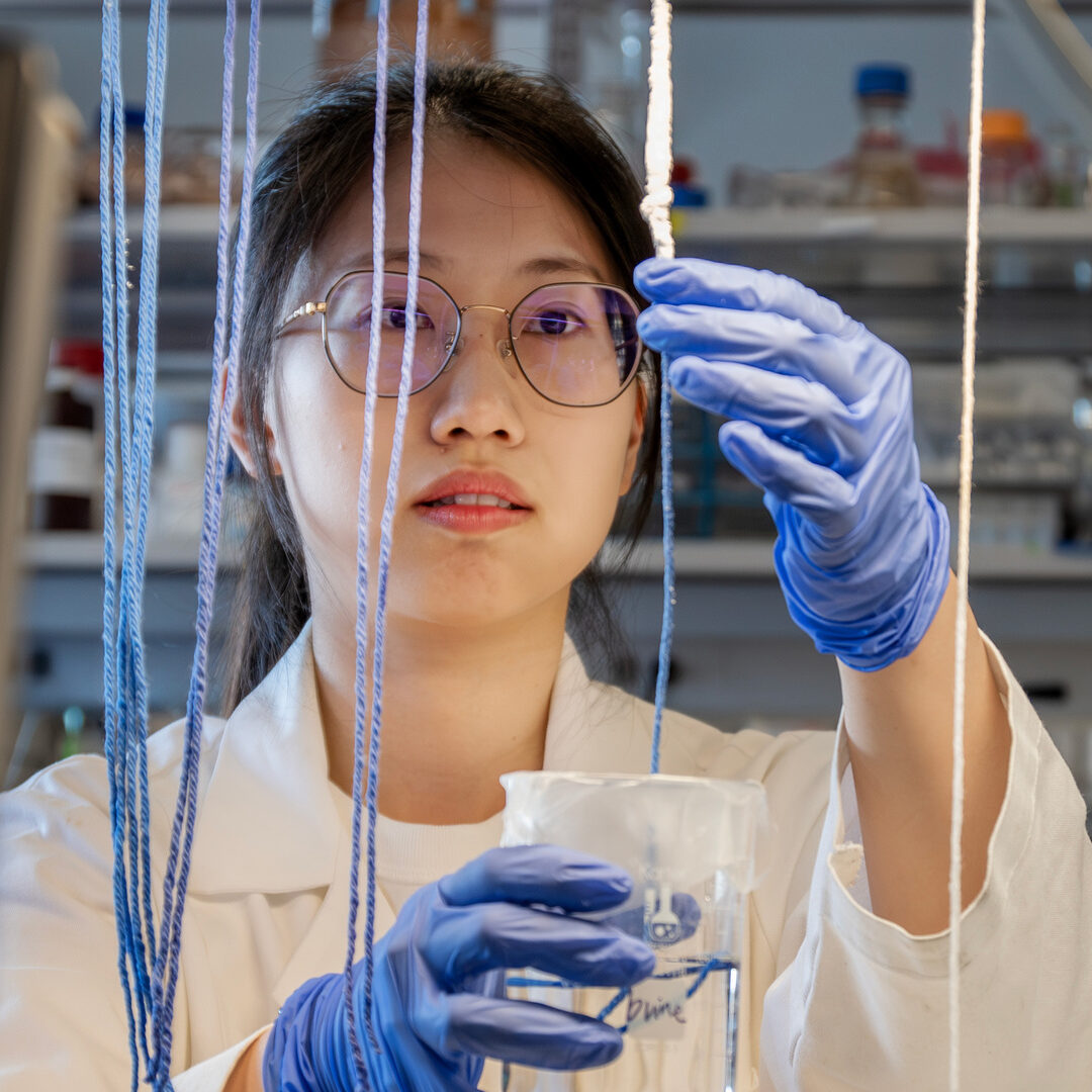 Civil and Environmental Engineering graduate student Meiqi Yang working on lithium extraction in a lab.