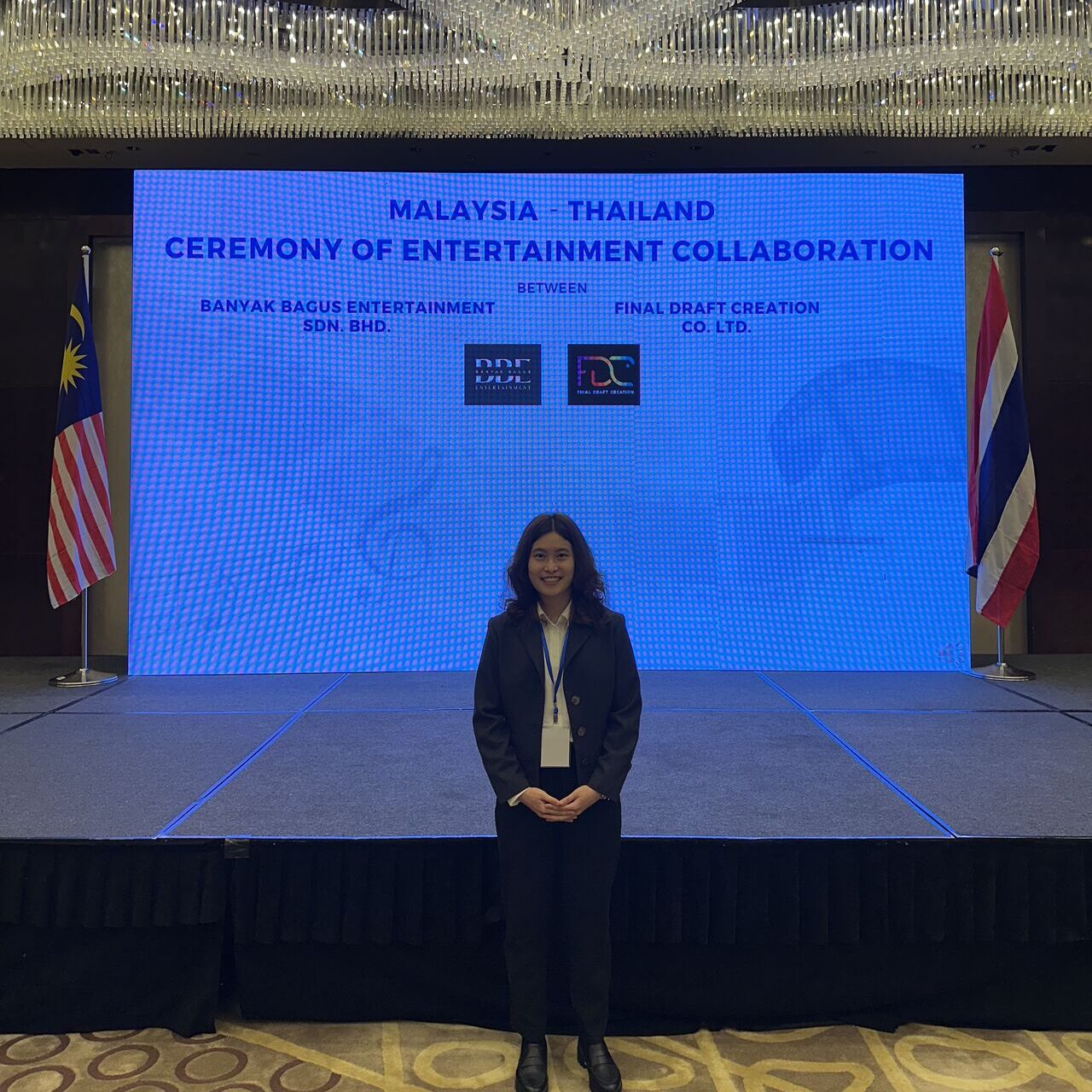 Mai standing in front of a stage in the Malaysian parliament.