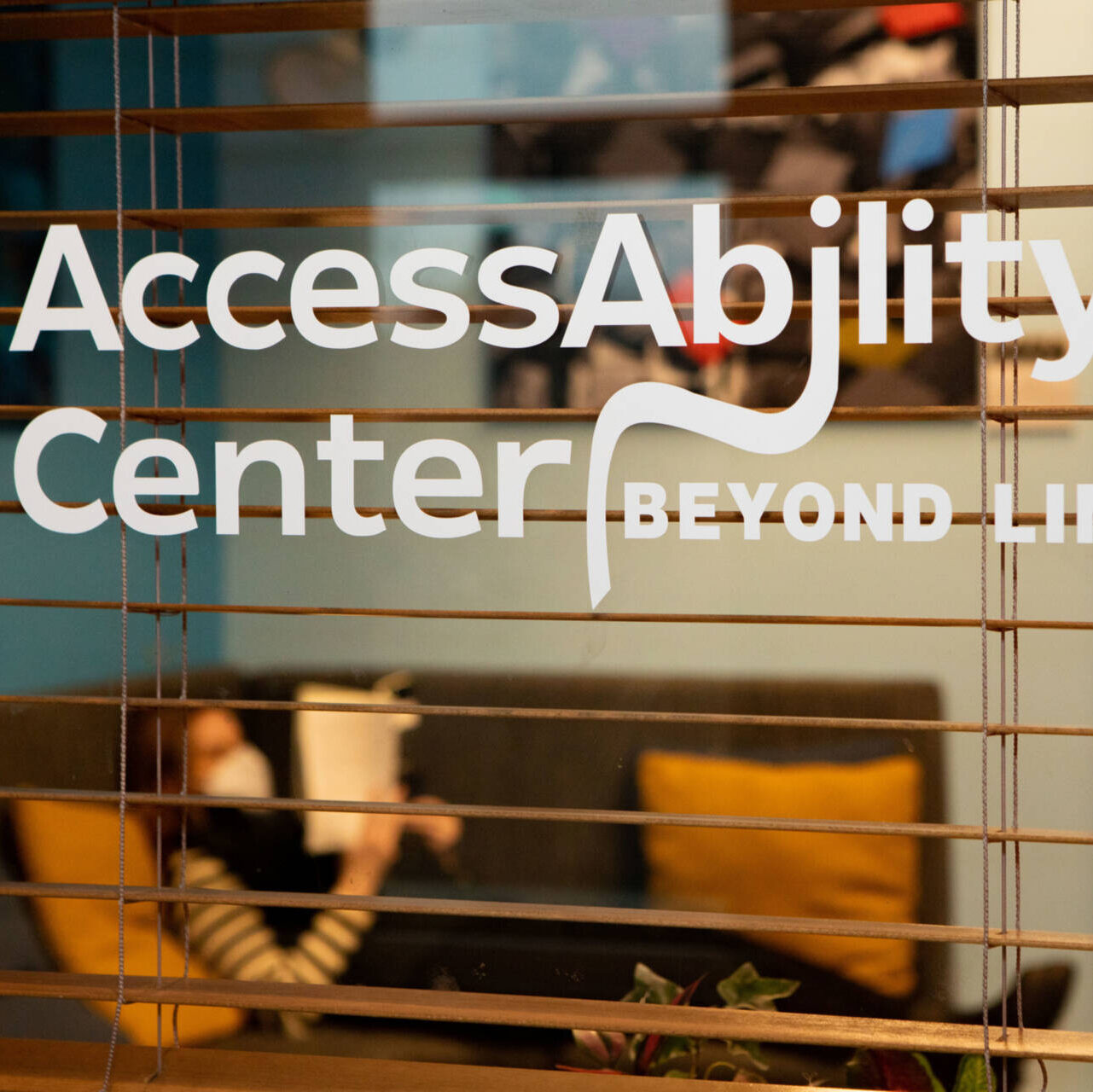 A photo of the AccessAbility Center in Frist Campus Center, with text reading "AccessAbility Center: Beyond Limits."