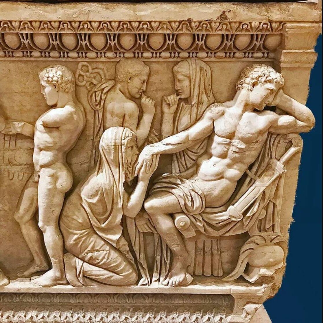 A sarcophagus depicting Priam kneeling and kissing Achilles' hand.
