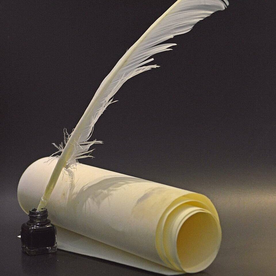 An ink quill and parchment.