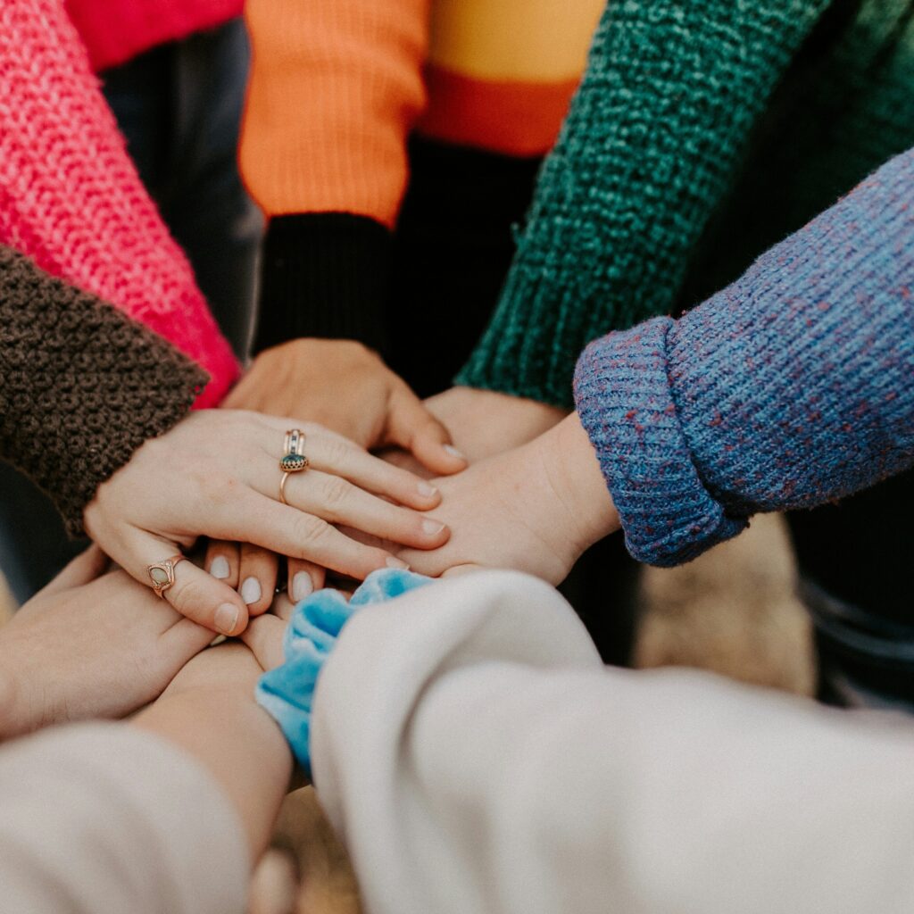Multiple hands joined together